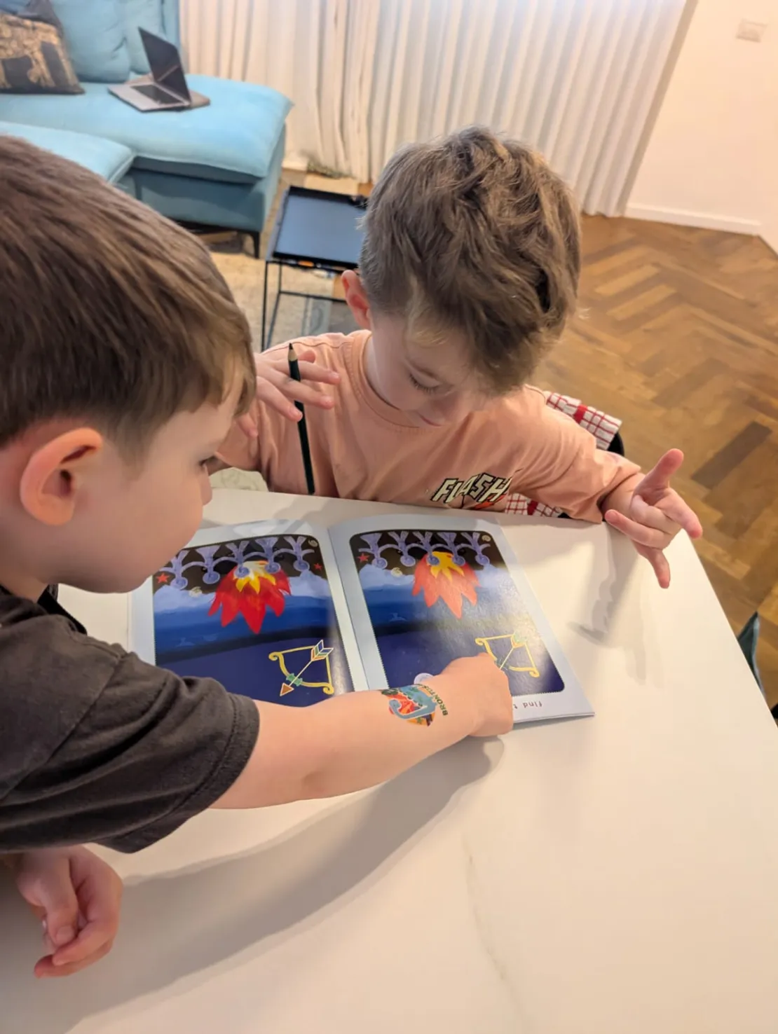 Two brothers reading Chodesh Magazine together