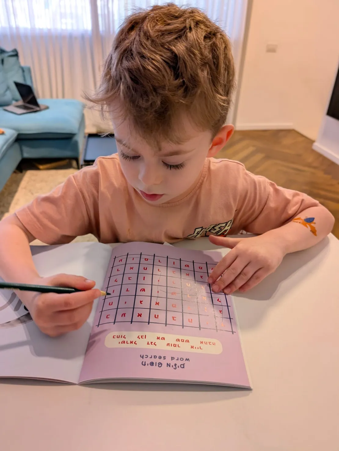 Child solving the Hebrew word search